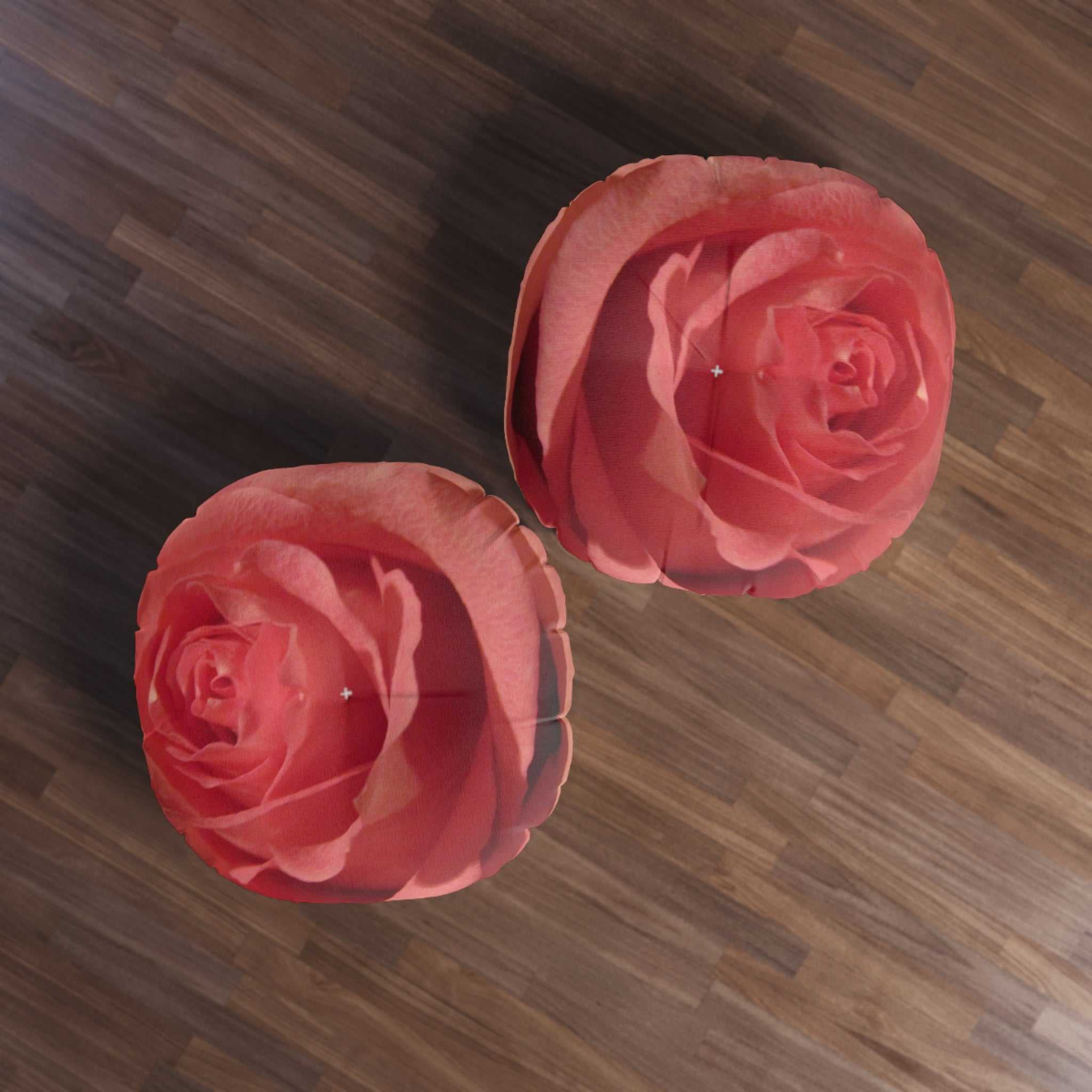 Two pink roses on a wooden floor