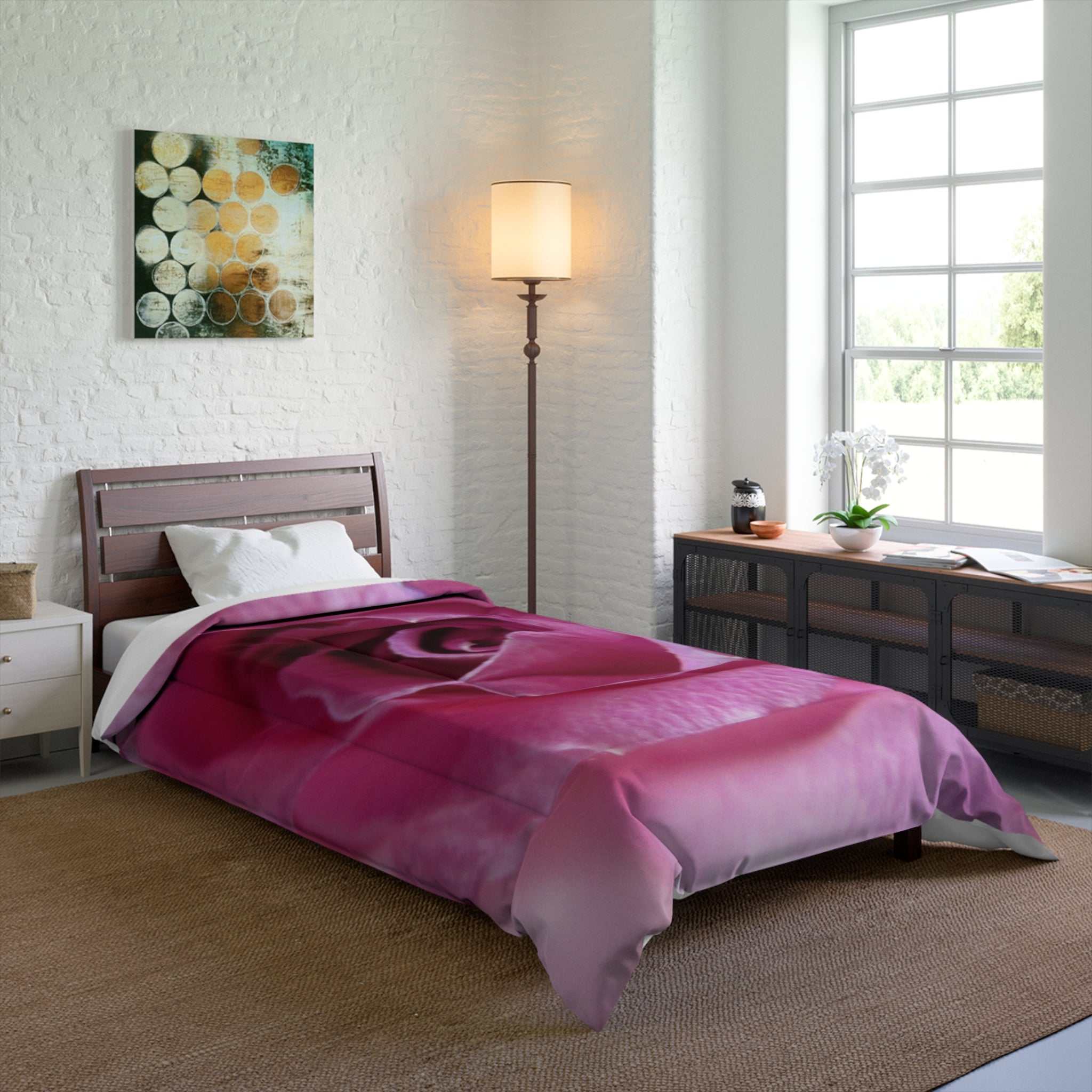 Bedroom with a pink rose comforter on a bed, lamp, and window.