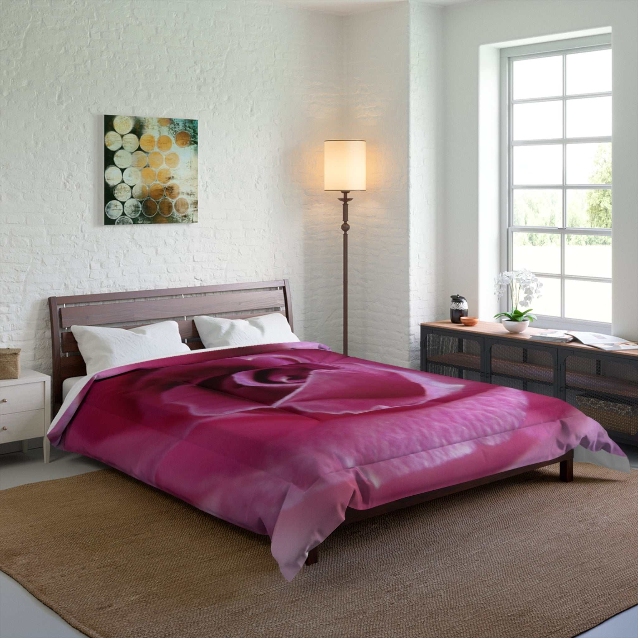 Bedroom with a bed covered in a pink rose-patterned comforter.